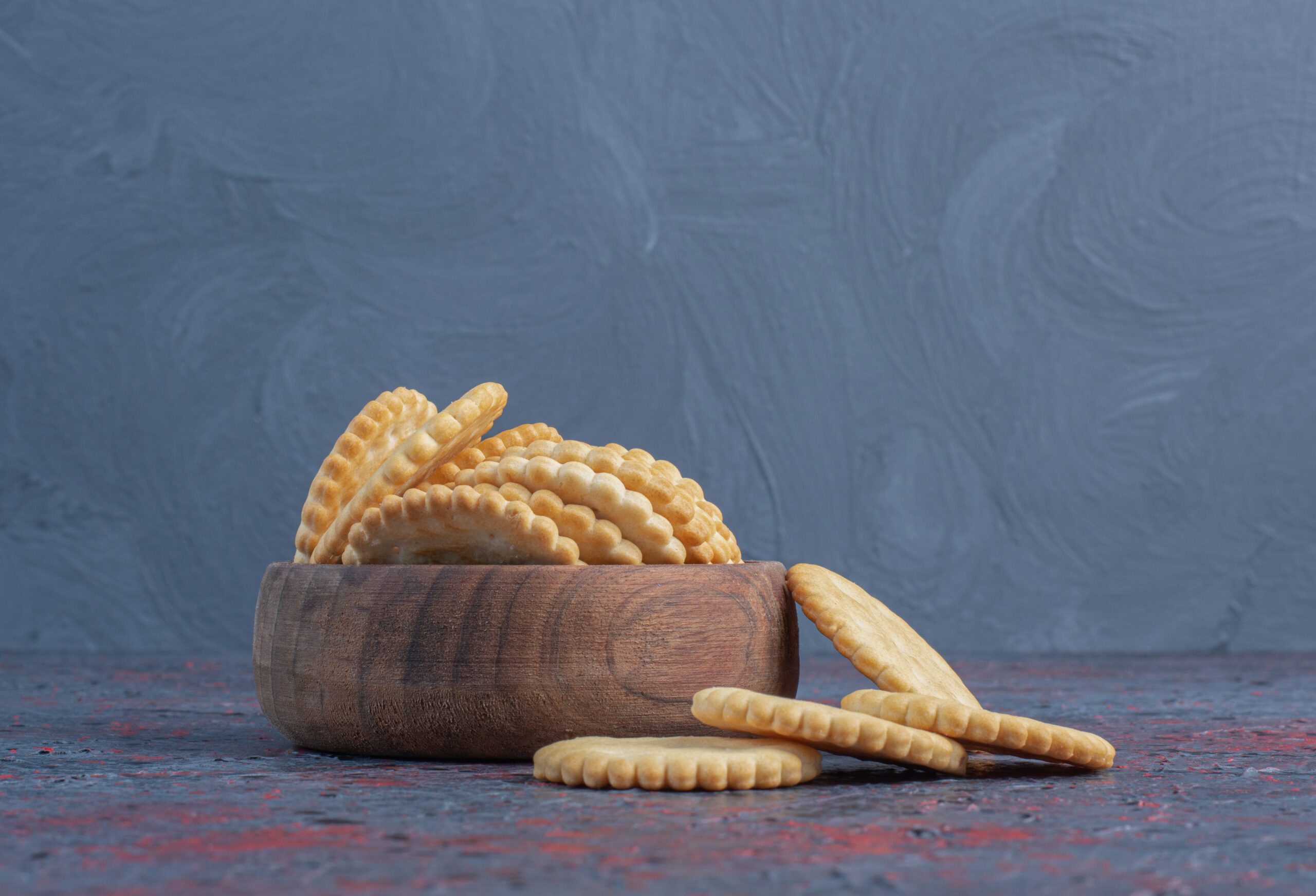 Biscuits in a small bowl on abstract background
